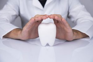 Dentist Hands Protecting Tooth